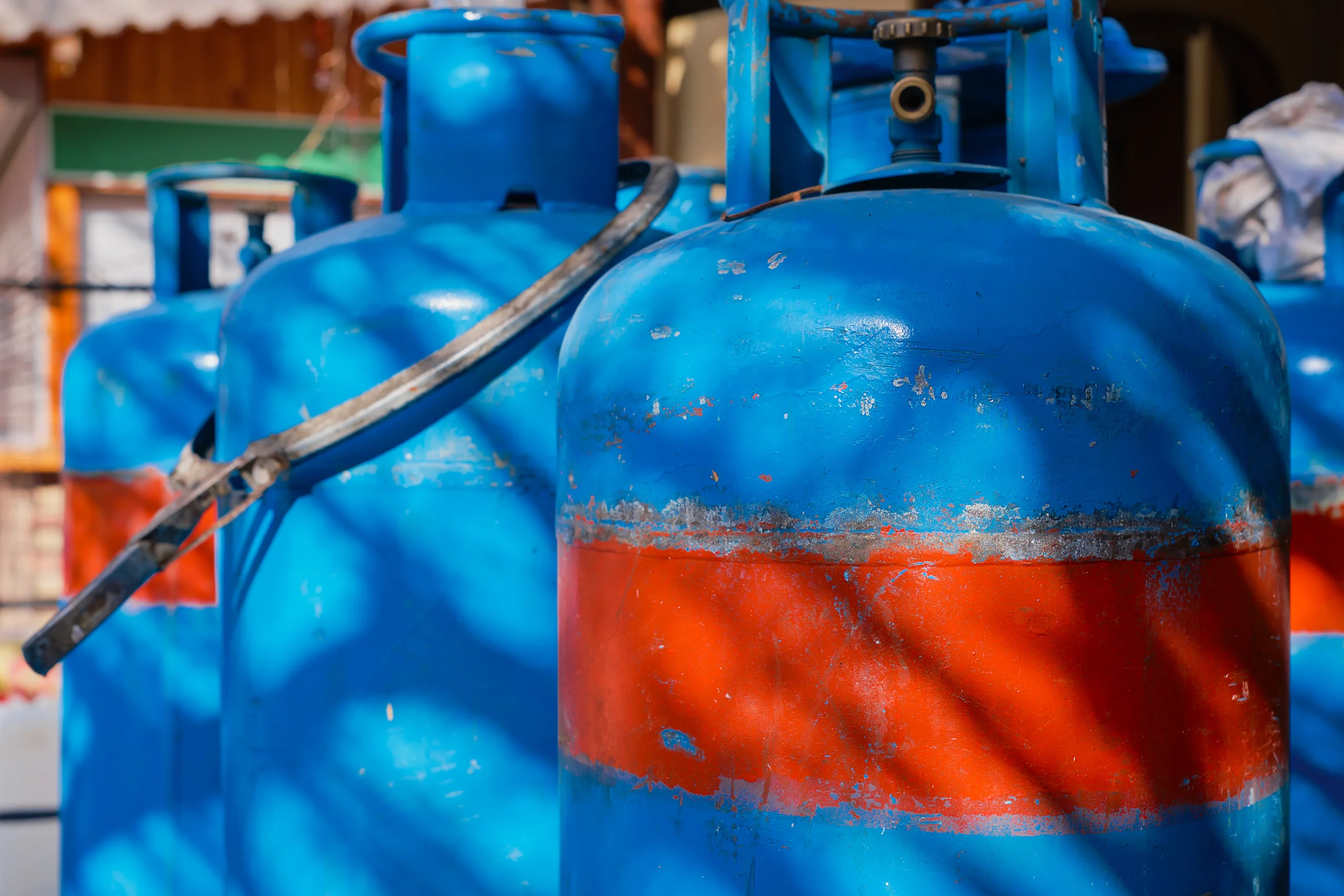 Blue gas cylinders with propane-butane for cafes and restaurants, selective focus, details of the narrow streets of the old city, Aegean sea travel